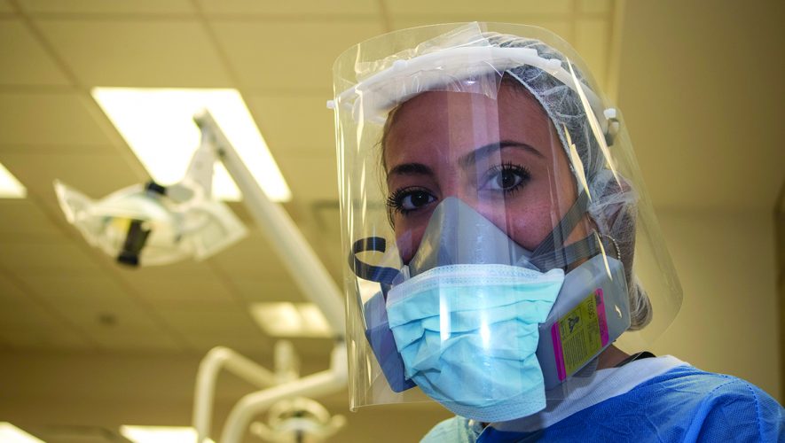 Dentist in personal protective gear due to COVID-19 pandemic