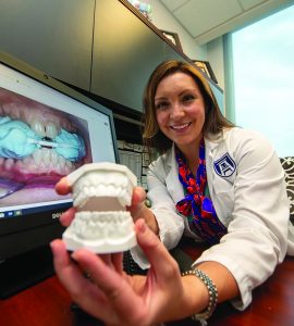 Woman showing model of teeth - Dr. Jacqueline Delash