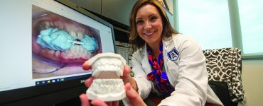 Woman showing model of teeth - Dr. Jacqueline Delash