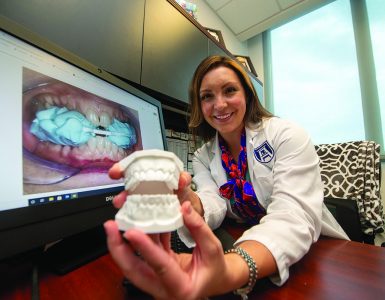 Woman showing model of teeth - Dr. Jacqueline Delash