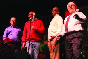 Four men singing together