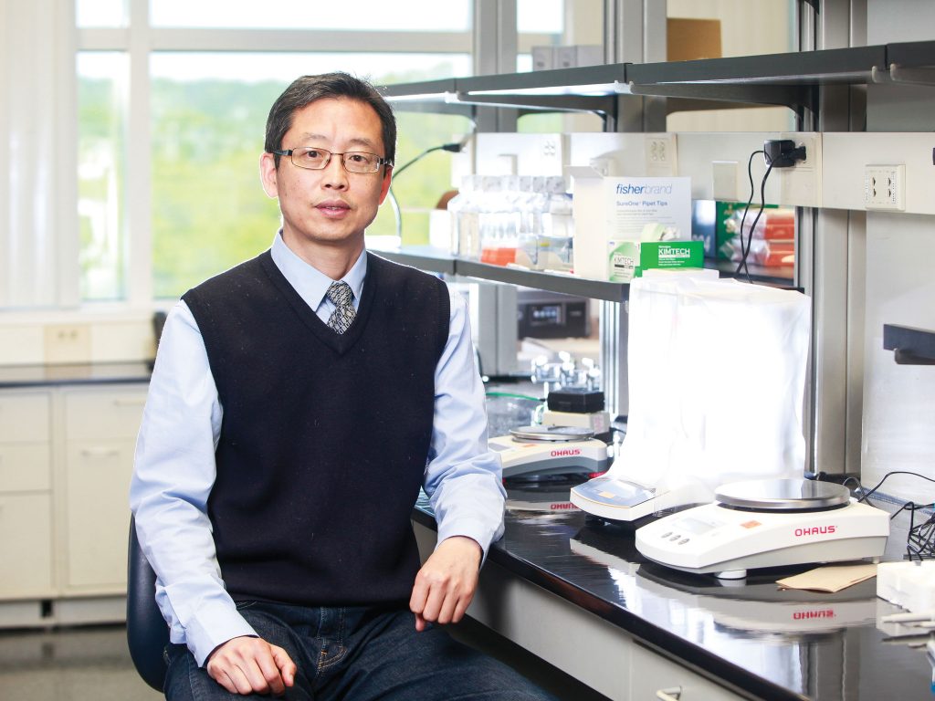 man sitting in lab posing for camera