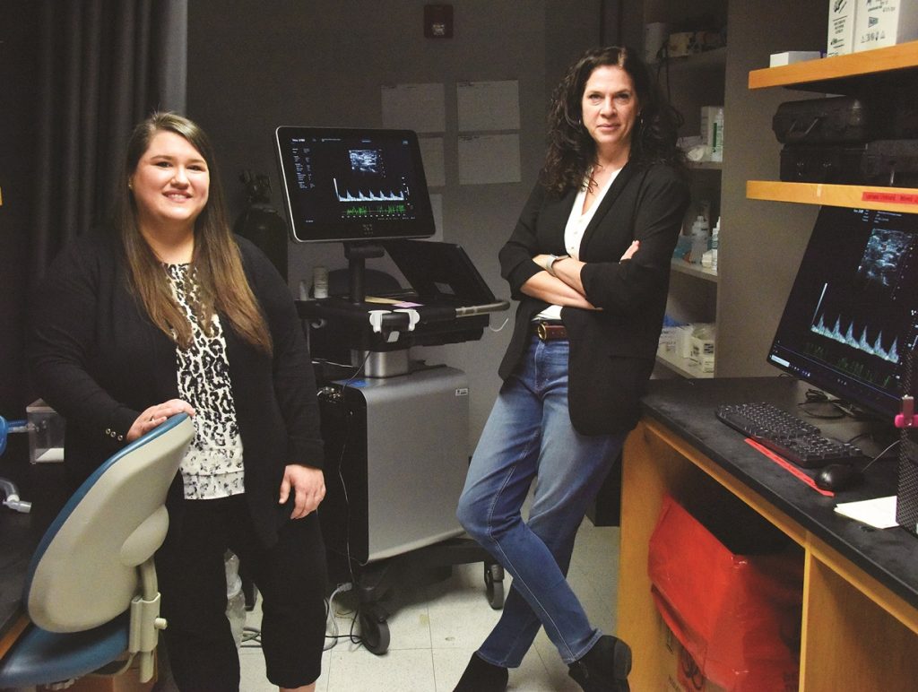 two female doctors smile and pose for picture