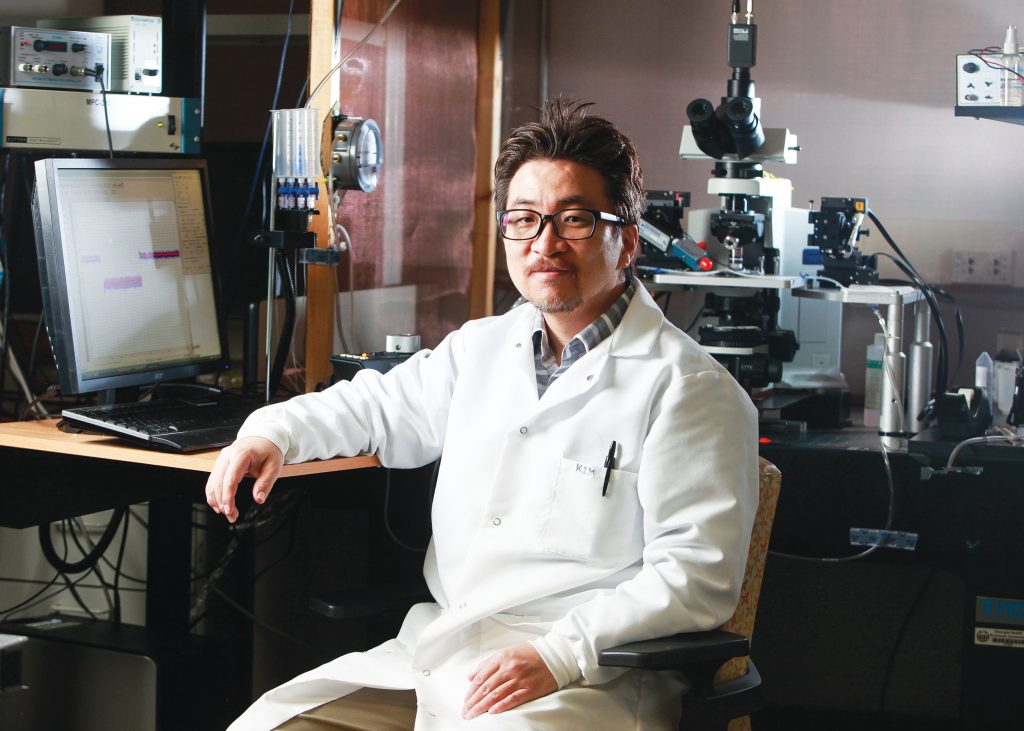 man sitting at lab posing for camera