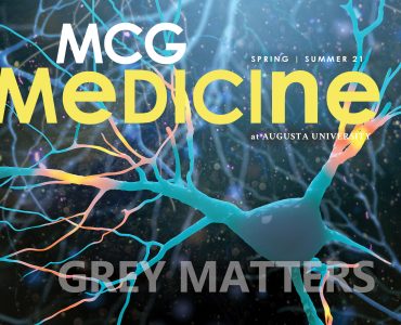 Cover of the MCG Medicine magazine- Spring Summer 2021 edition. Background of neuron