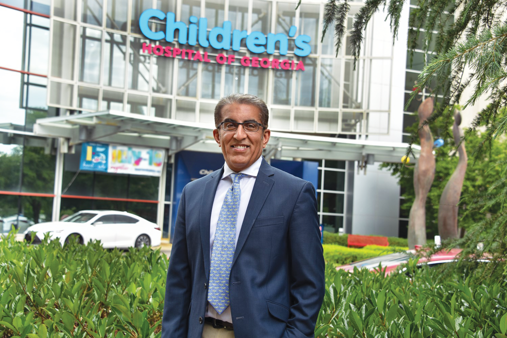 Man stands in front of Children's Hospital of Georgia smiling at camera.