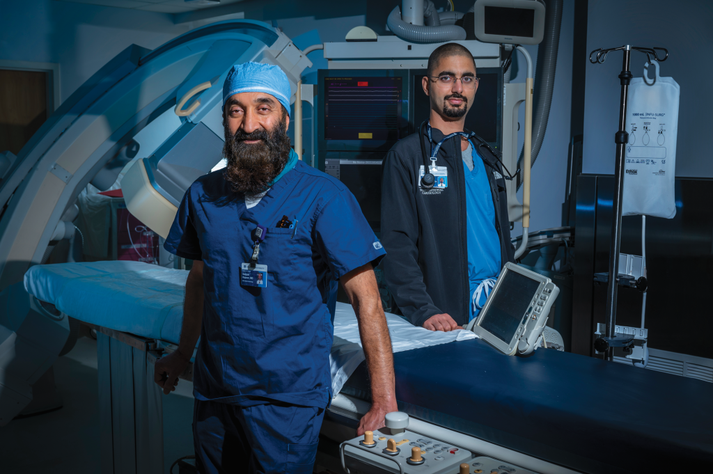 Two male doctors pose for photo in lab