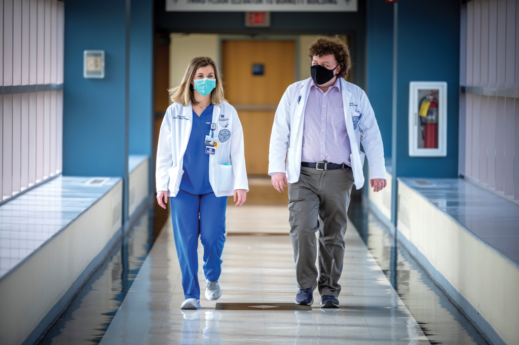 two doctors walk down hospital hall
