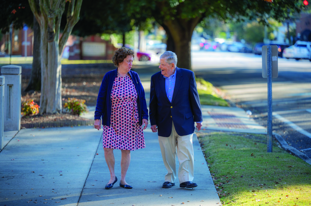 older couple walking down sidewalk