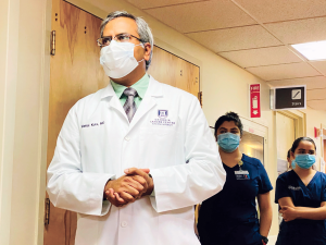 doctor and nurses walking in hospital hallway