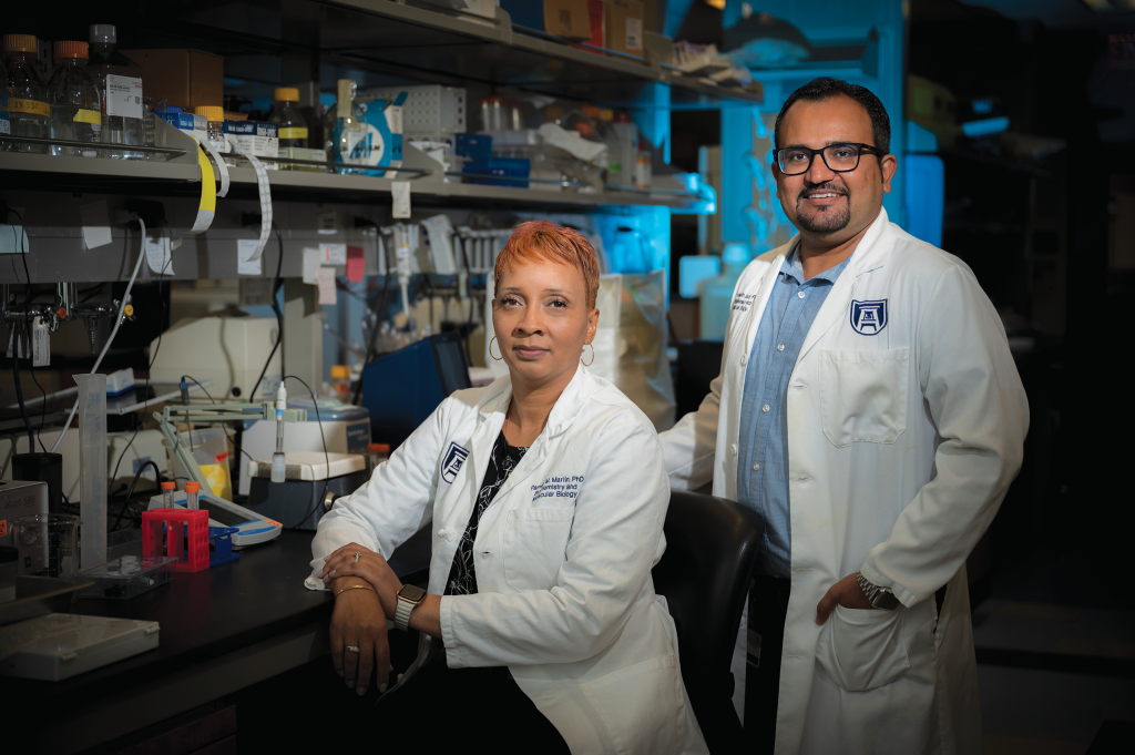 Woman and man posing in lab