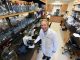 man in lab smiles at camera