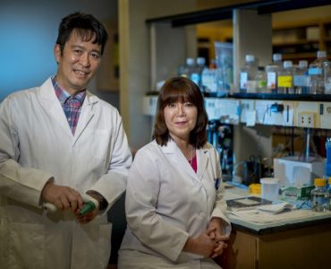 Scientists pose in lab for camera