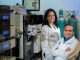 scientists pose in lab for camera