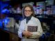 woman scientist smiles into camera