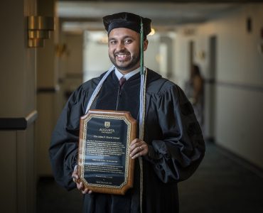 Man holds up award for camera