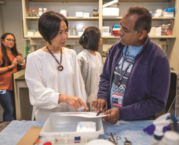 Dr. Qi Wang, left, talks with Dr. Hasibur Rehman as they work in her lab