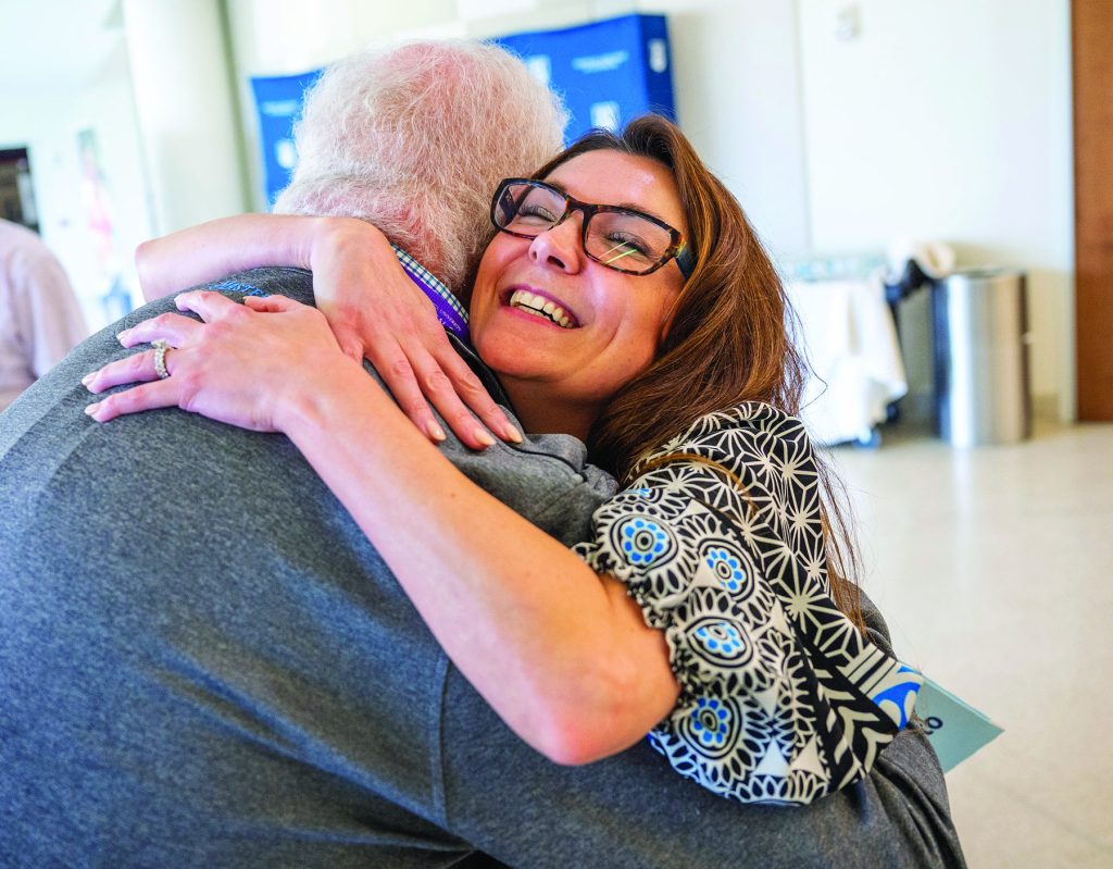 Woman hugs man