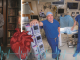 Three men pose for camera in two different photos next to each other. One in his office, the other two together in surgical room. Heart rate monitor and human heart graphic in middle of page.