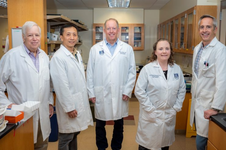 scientists in lab posing for camera