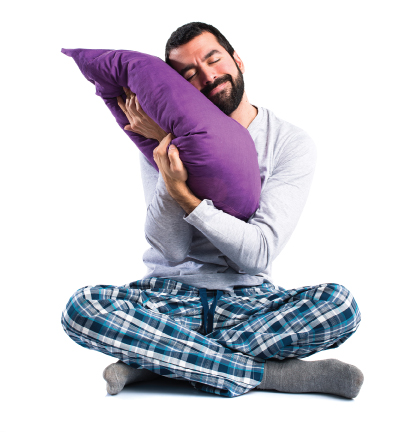 man sitting hugging pillow